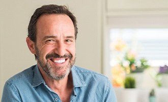 man smiling after getting dental implants